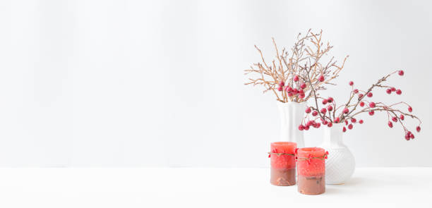 istock Christmas, New Year home decor. Branches with red berries in a vase, golden branches on a light background. Mock up for displaying works 1346938962