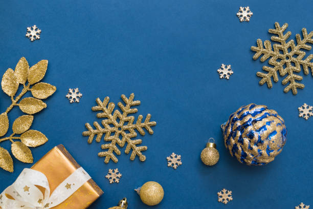 istock Christmas holiday composition. Flat lay frame with christmas balls and gift box on a blue background 1346938972