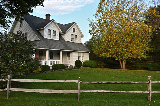 House in the country, autumn, with split-rail fence in front. Taken in Connecticut.