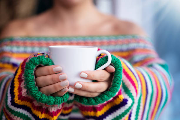 Woman drinking italian cappuccino in Italy, outdoors. Europe. Nikon. No logo.