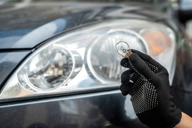 istock mechanic change low-beam or high-beam light bulb in his car 1346941810
