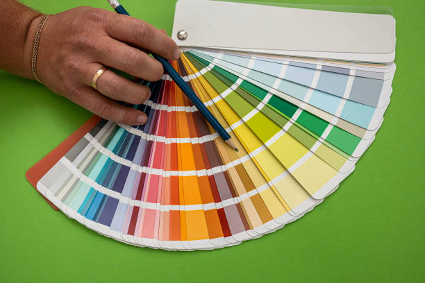 istock male hand shows colored samples isolated on green background 1346943300