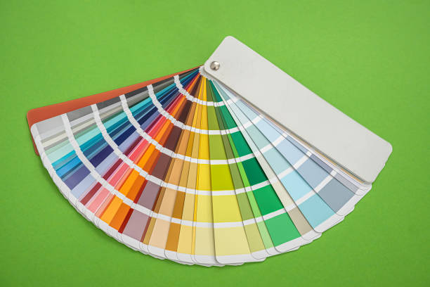 istock Colored new fan templates with different colors stand on a green background 1346943972