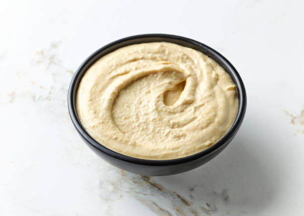 istock bowl of hummus on kitchen table 1346949652