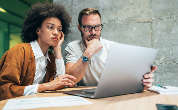 istock Two business people working together in office 1346950951