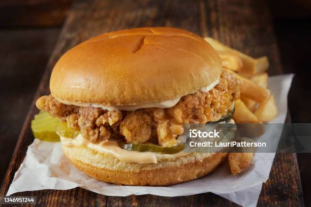 Spicy Crispy Fried Chicken Burger With French Fries Stock Photo - Download Image Now