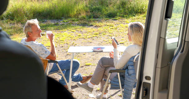 istock Mature couple enjoy breakfast outside camper van 1346952605