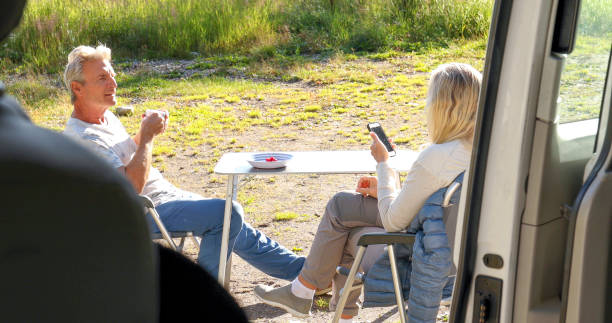 istock Mature couple enjoy breakfast outside camper van 1346953202