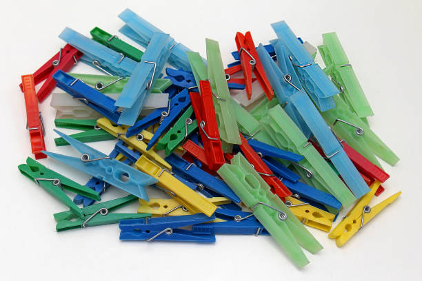 Plastic colorful clothes pegs clips stock photo