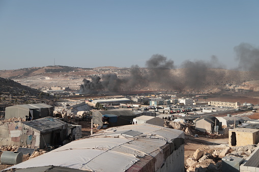 Syria - Idlib October 16, 2021 Pictures show a scene of smoke rising from a warehouse with artillery shelling by the Syrian regime and Russia, and also vital and service facilities were bombed on the road between Bab al-Hawa and the city of Sarmada near the Turkish border