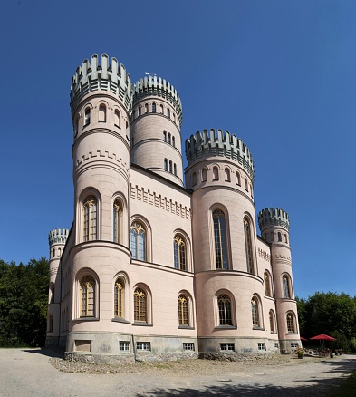Binz, Germany, August 7, 2020: View of the Granitz Hunting Castle (German: Jagdschloss Granitz) on a summer day from a public park. It is located on the island of Rügen on a wooded mountain near Binz. With over 250,000 visitors a year, it is the most visited castle in Mecklenburg-Western Pomerania.