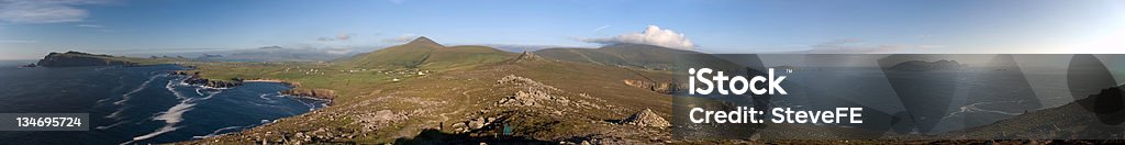 Europe's End Panoramic of the Dingle Peninsula, Co Kerry, Ireland, shot from near the western tip at Clogher Head. Left to right: Sybil Head, the Three Sisters, Ballydavid Head, Brandon Mountain (in cloud), Croagh Martin, Mount Eagle, and the Great Blasket Island on the right. Atlantic Ocean Stock Photo