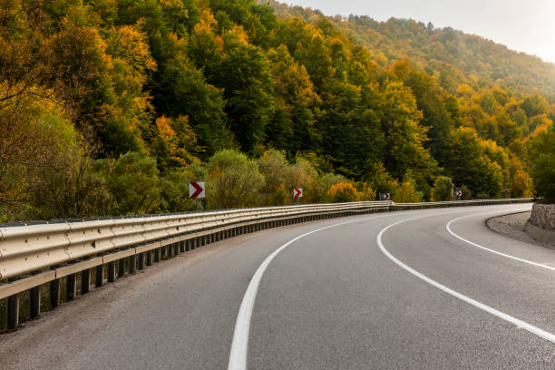 istock Highway and autumn landscape with vibrant fall colors. 1346957933