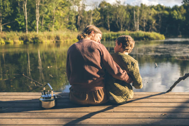 istock Mother and son relaxing at a lake 1346958598