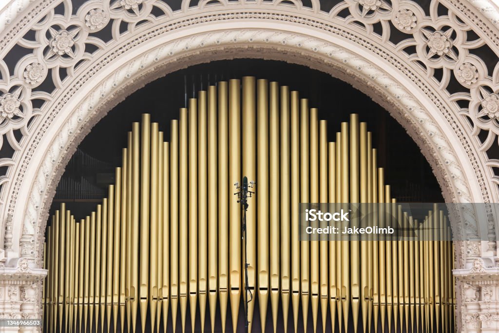 Organ Pipes Photo of golden organ pipes in an archway. Antique Stock Photo
