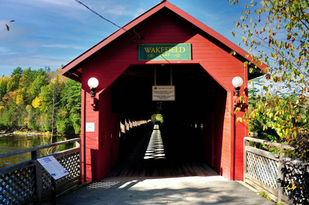 istock Covered bridge in Wakefield Quebec in autumn colors 1346976020