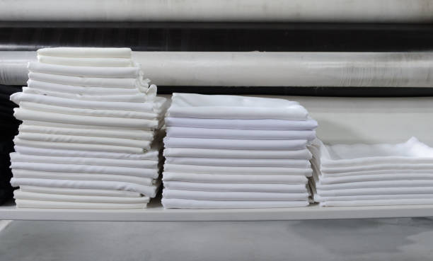 istock Stack of folded black and white cloths in an industrial laundry. 1346987453
