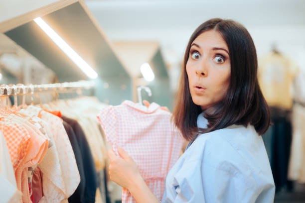 surprised mom checking little dress for her daughter - cheep imagens e fotografias de stock