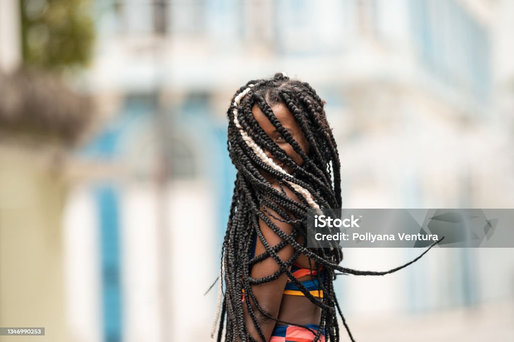 Afro woman hiding face with braids Afro, Woman, Hiding, Braids, Portrait Braided Hair Stock Photo