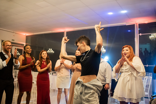 Non-binary person dancing at a party