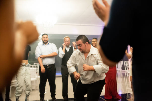 istock Man with down syndrome dancing at the party 1346995559