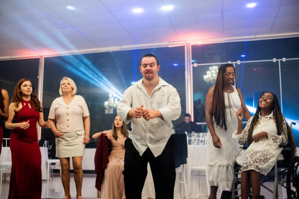 istock Man with down syndrome dancing at the party 1346995567