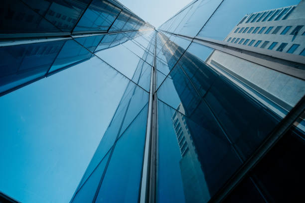 istock Office building exterior with reflection and blue sky in city centre 1346996427