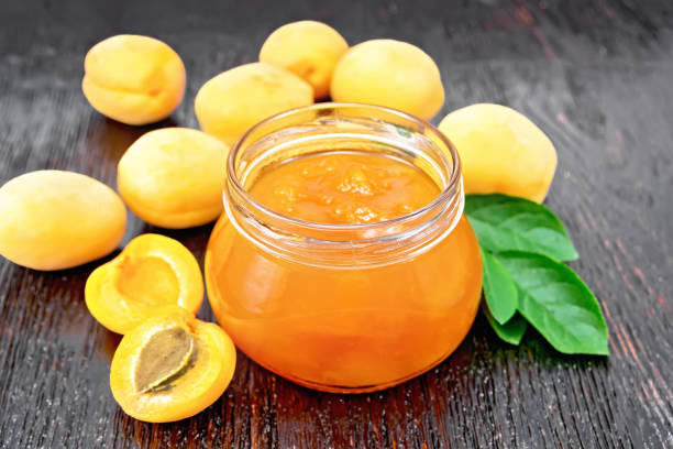 istock Jam apricot in jar on board 1346998324