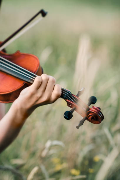 istock Girl Playing Violin 1346998492