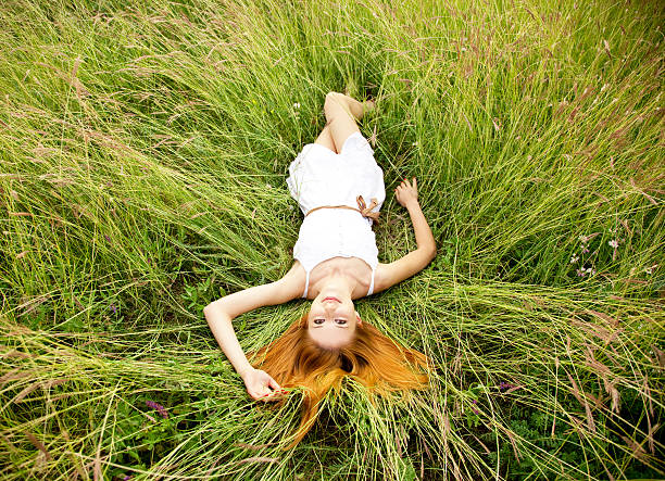 istock Beautiful girl lying down at grass. 134699978