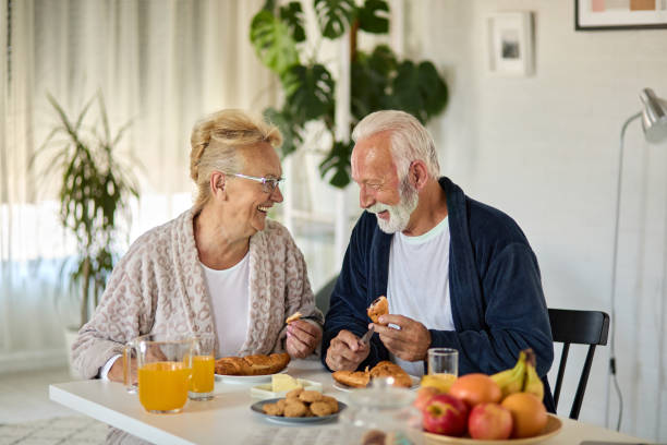 istock Beautiful senior couple having breakfast at home 1347002099