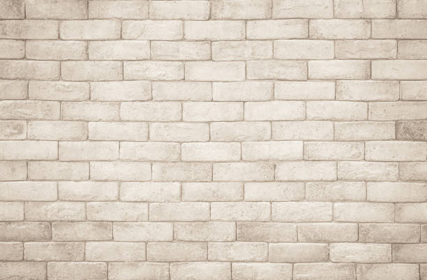 cream and white brick wall texture background. brickwork and stonework flooring interior rock old pattern clean concrete grid uneven bricks design stack. background of old vintage brick wall - cast in stone imagens e fotografias de stock