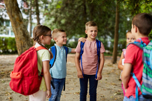 istock Group of school children talking together in schoolyard 1347003343