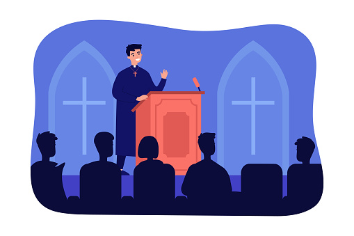 Catholic priest speaking on podium of church
