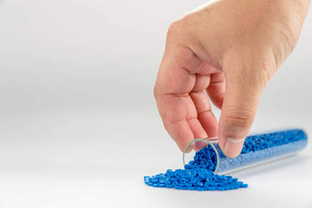 istock Hand holding plastic tube. polymer pallet. plastic beads. wax pallet. 1347011479