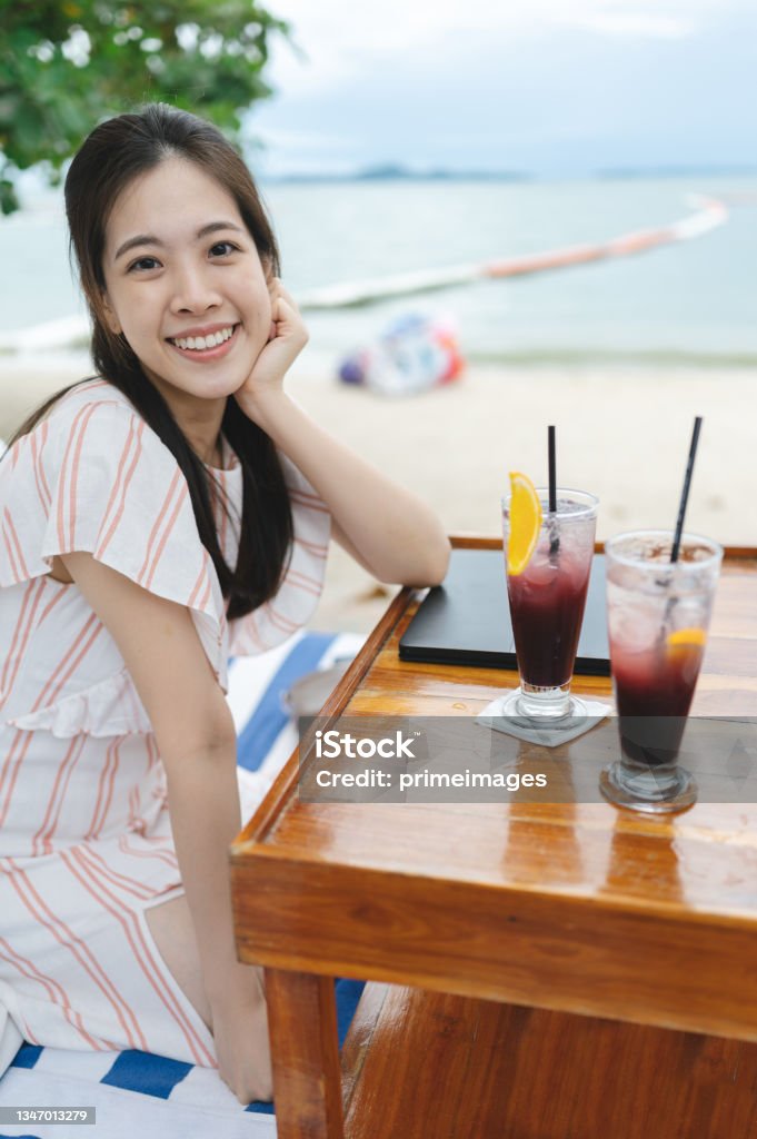 Happy vacation on the beach enjoy cocktail and potato fried in beach cafe at weekend Beach Stock Photo