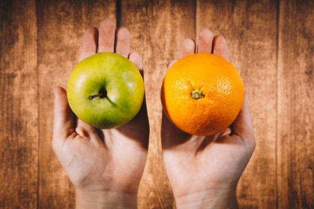 istock Comparison of apples with oranges. 1347013435