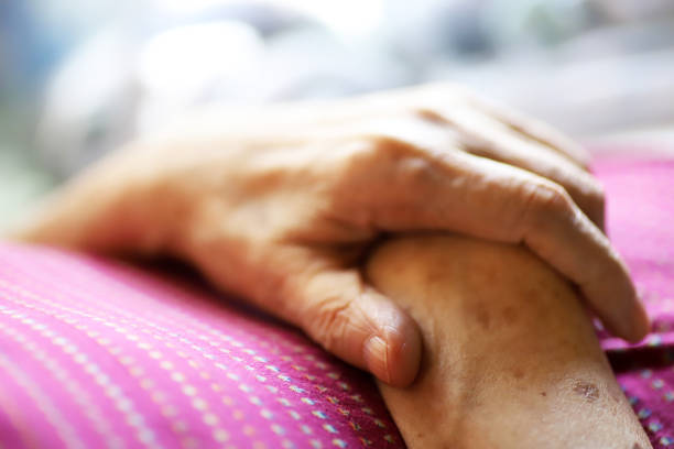 istock Close-up of an elderly woman's hands lying in a nursing bed 1347014313