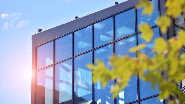 istock Reflection of modern commercial building on glass with sunlight. Eco architecture. 1347015101