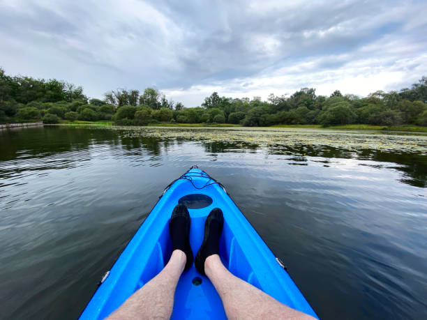 blue kayak in loch lomond on open water - loch rowboat lake landscape imagens e fotografias de stock