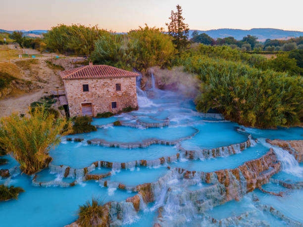 natural spa with waterfalls and hot springs at saturnia thermal baths, grosseto, tuscany, italy,hot springs cascate del mulino with old watermill, saturnia, grosseto, tuscany, italy - waterfall health spa man made landscape imagens e fotografias de stock