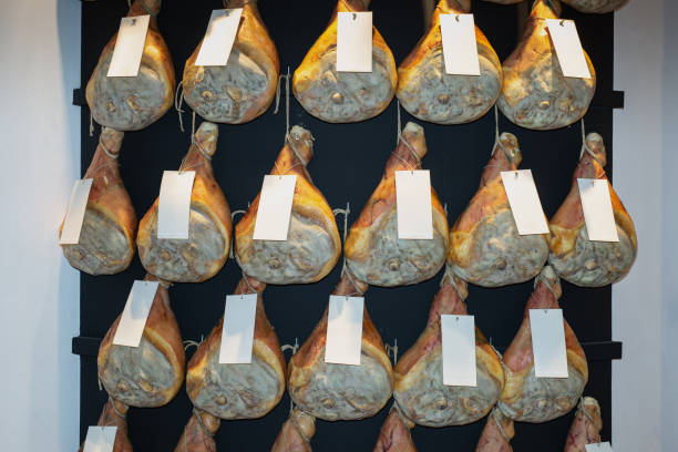 istock Group of Whole Raw Hams hung on a Wall 1347019220