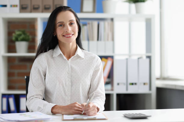 istock Smiling female business consultant at working table in office 1347020211