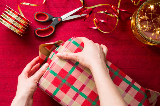 istock Top view of hands wrapping gifts. 1347021271