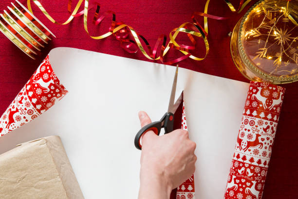 istock Top view of hands wrapping gifts. 1347021339