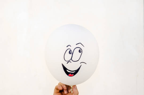 istock Positive white balloon with a laughing painted face against a li 1347022229