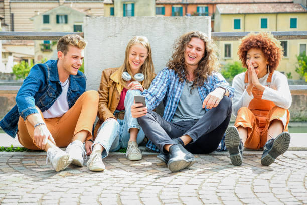 istock Multicultural group of friends using mobile phones - Students sitting together in a row and typing on smartphones - Concepts about technology addiction and youth 1347026645