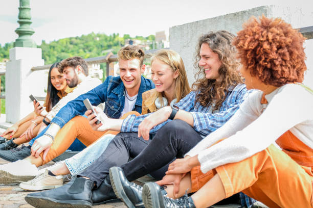 istock Multicultural group of friends using mobile phones - Students sitting together in a row and typing on smartphones - Concepts about technology addiction and youth 1347026840