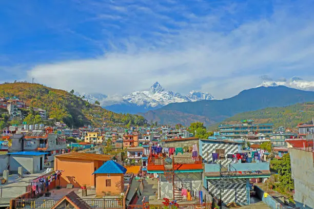The photo shows a panoramic view of Pokhara (Nepal). On background one can see Mt Fishtail / Machapuchare (6.999 mt) in the Himalayan range.
