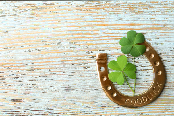istock Clover leaves and horseshoe on light wooden table, flat lay with space for text. St. Patrick's Day celebration 1347030077